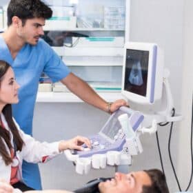 Ultrasound examination in the medical laboratory with doctor and patient.