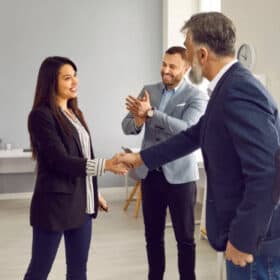 Business handshake during offboarding in the office.