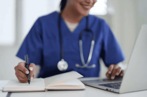 Medical specialist with laptop and notebook